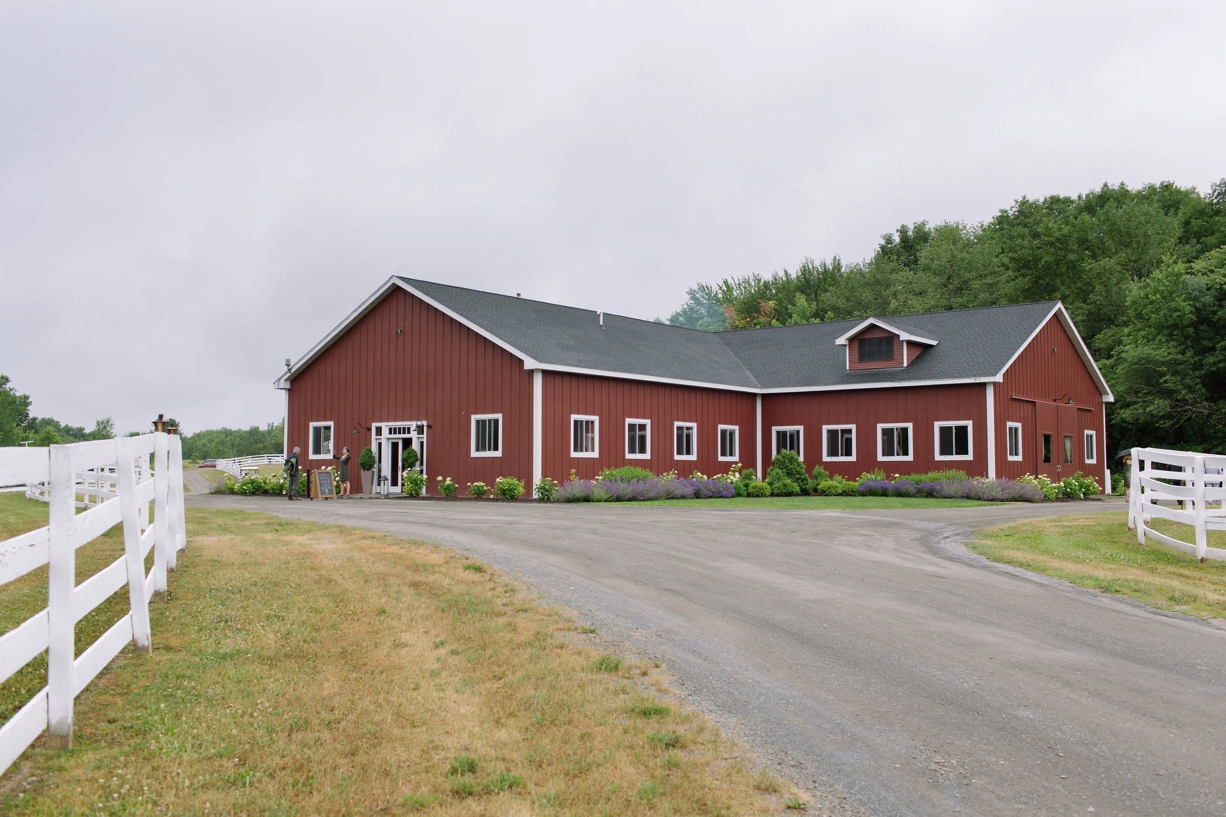  Liberty Farm is recognized when it comes to picturesque farm wedding venues in the Hudson Valley. This certified organic farm in Columbia County, New York, offers 300 acres of beauty. You’ll love your wedding here.  Liberty Farm used to be a thoroughbred-breeding facility but is a state-of-the-art horse training and boarding facility today. It also offers a refurbished stallion barn that is just perfect for weddings. This space can host up to 150 wedding guests and has heating and air conditioning.&nbsp;  Getting to Liberty Farms involves passing through a gorgeous sleepy bucolic road that leads up to the 300 acres. You’ll also love that this space has views of both the Berkshire and Catskills Mountains. A grand lawn, manicured paddocks, and up-to-date facilities are the other attractions of this venue.  For your wedding, Liberty Farms offers a beautiful upscale barn. However, they can set up an optional tent if you need one for your celebration. You can start your day with a stunning first look on the hilltop and then take beautiful pictures at the grand entrance with massive curtains.&nbsp;  Couples also love the fire pit and the exclusivity that this venue offers. They host only one wedding per weekend, and guests are free to walk around and even play lawn games. It’s the perfect getaway space for an unforgettable weekend.&nbsp; 