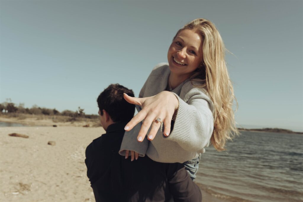 Playful newly engaged couple on Sandy Hook beach — NJ documentary wedding photographer